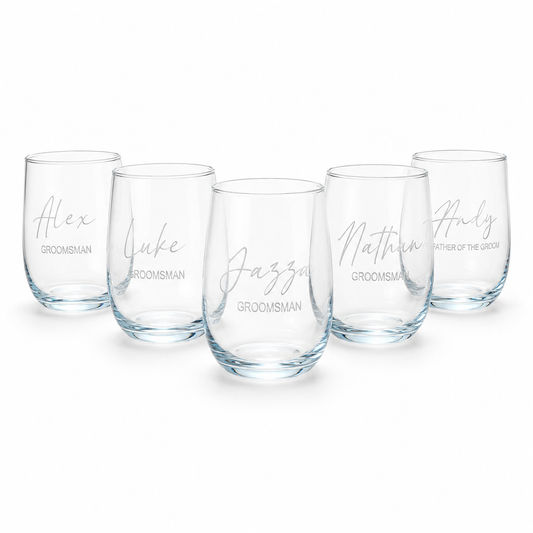 Set of five clear glasses with personalized names on a white background
