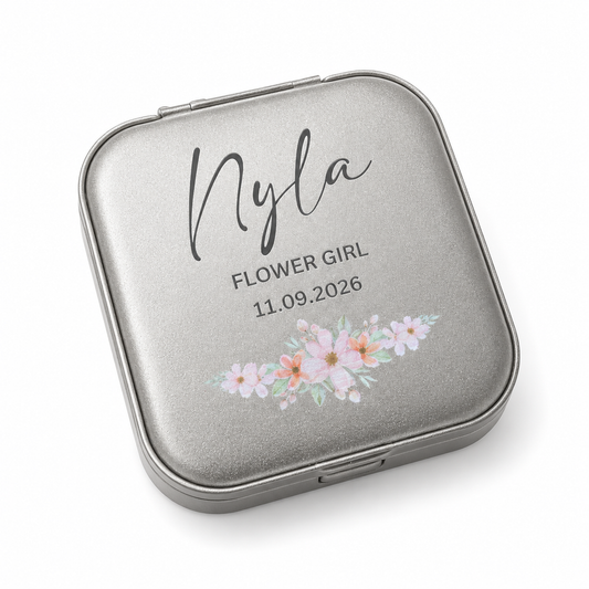 Silver compact mirror with floral design and personalized text on a white background