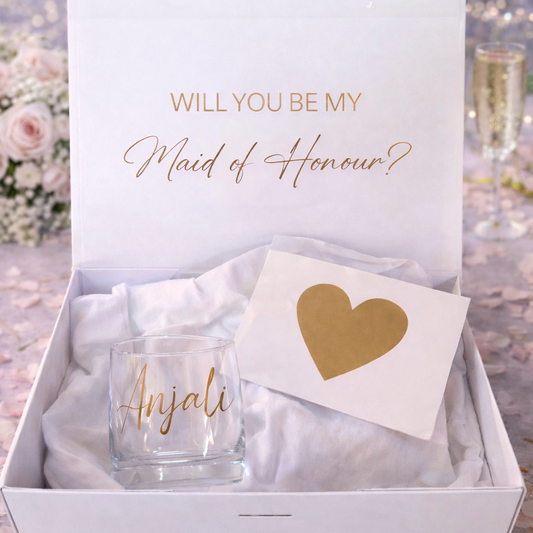 Gift set with a card and glass in a box, asking 'Will you be my Maid of Honour?' on a glittery background.
