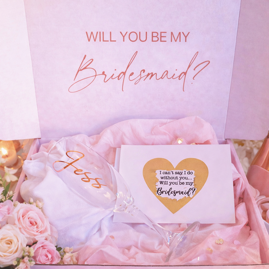 Pink gift box with 'Will you be my Bridesmaid?' card and flowers.
