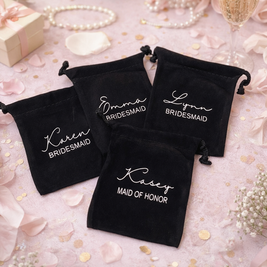Black drawstring bags with personalized names on a decorative background