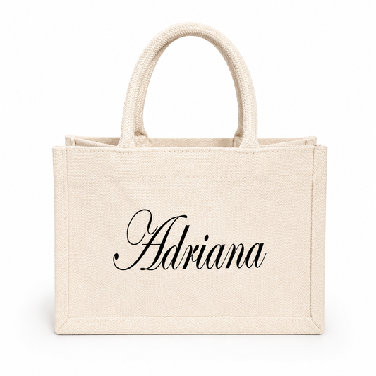 Beige tote bag with 'Adriana' printed on a white background