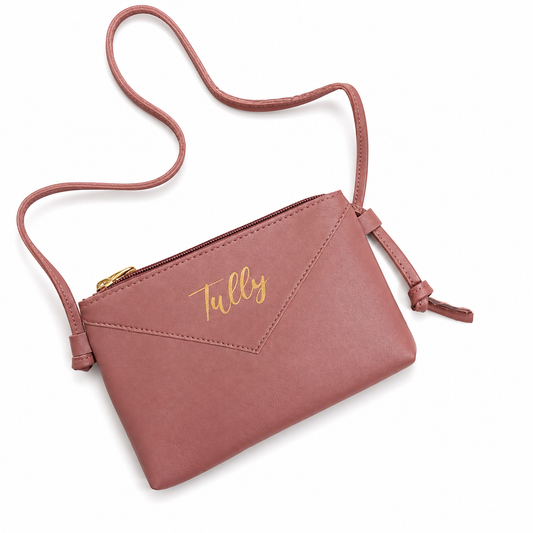 Pink crossbody bag with 'Tully' branding on a white background