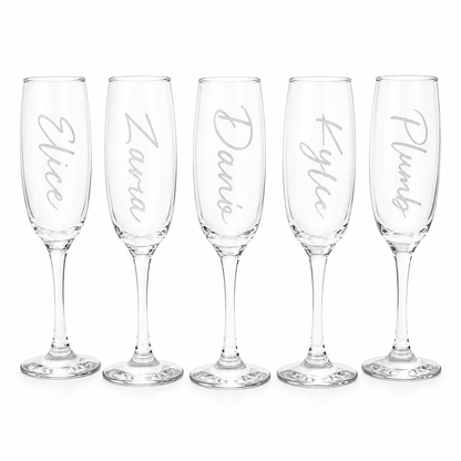 Set of five personalized champagne flutes with names engraved on a white background