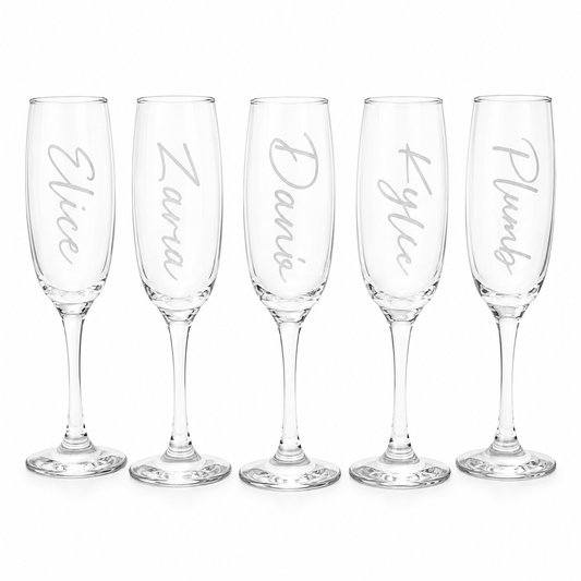 Set of five personalized champagne flutes with names engraved on a white background