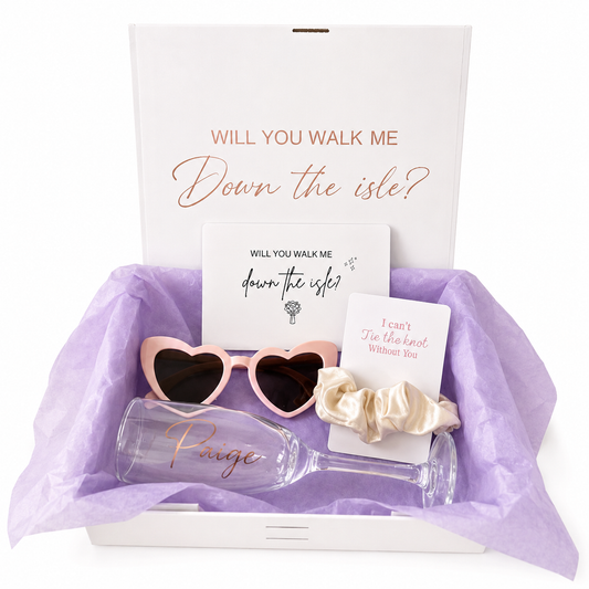 Wedding accessories including sunglasses, wine glasses, and a card on a white background