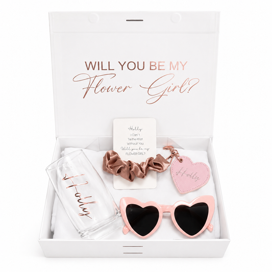 Gift set with 'Will You Be My Flower Girl?' card, sunglasses, scrunchie, and keychain in a box.