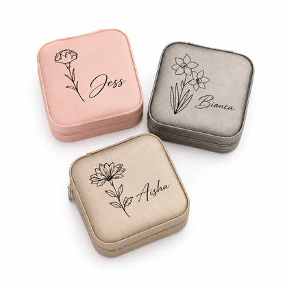Three small jewelry cases with floral designs and names engraved on a white background