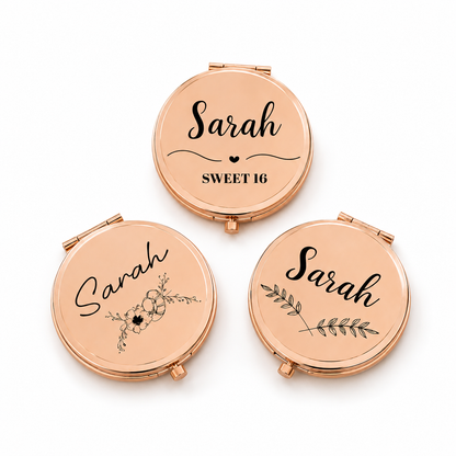 Three rose gold compact mirrors with personalized designs on a white background