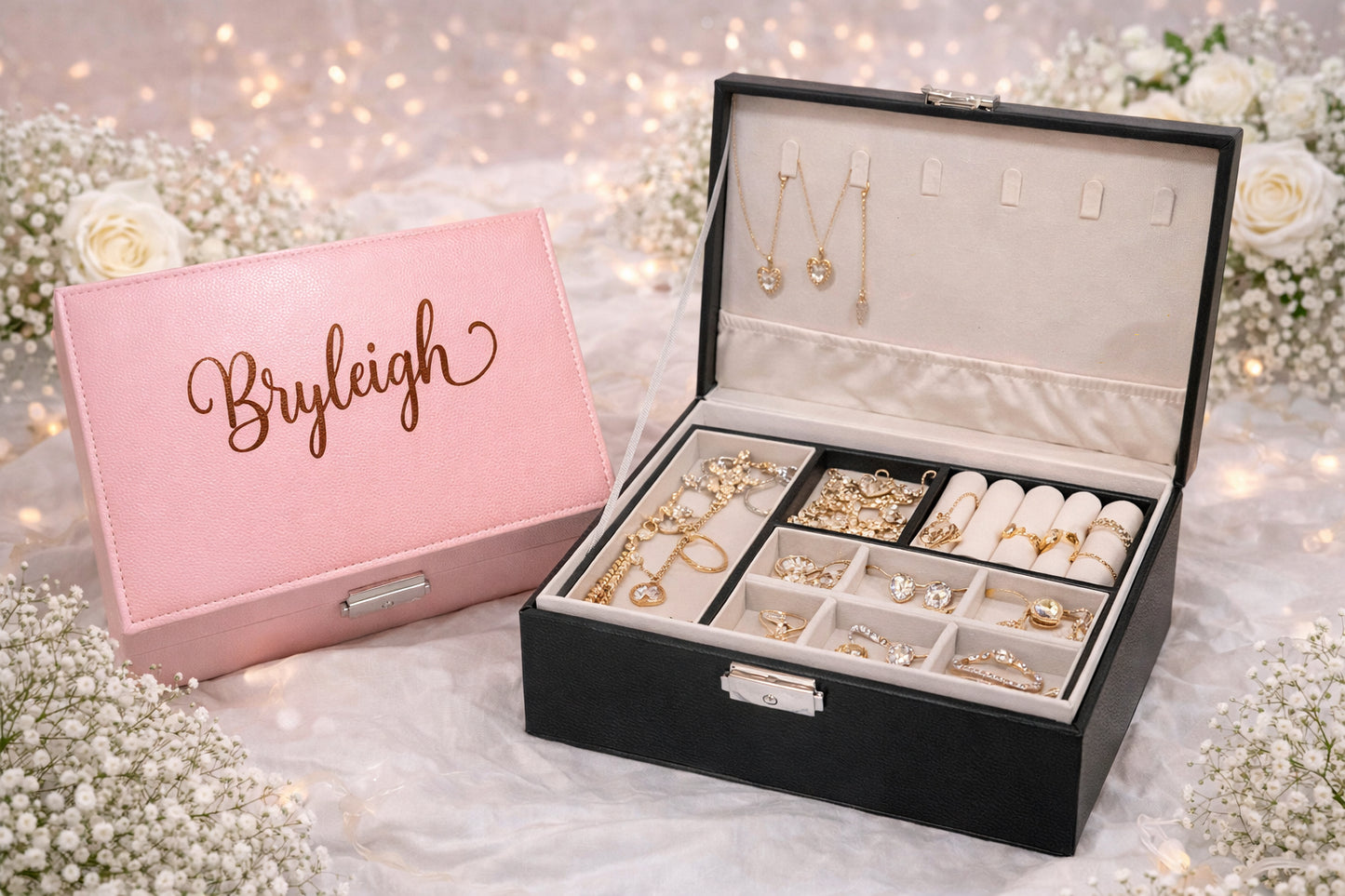 Jewelry box with 'Bryleigh' on a pink cover, filled with jewelry on a decorative background.