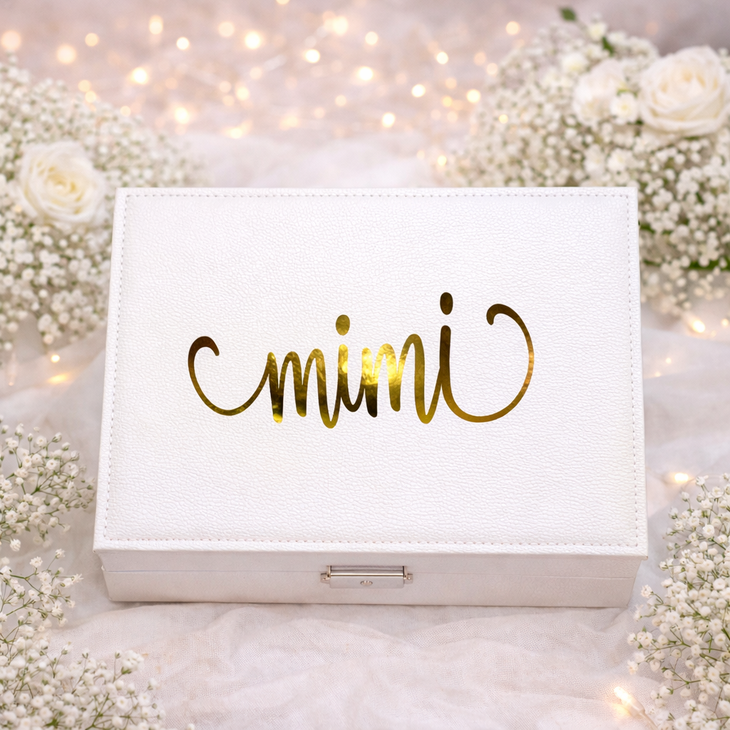 White jewelry box with 'mimi' in gold letters on a floral background