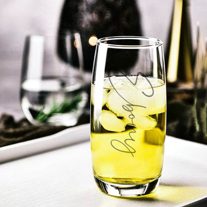 A set of clear engraved hiball glasses displayed on a reflective surface, with one glass engraved with the name 'Olivia'.