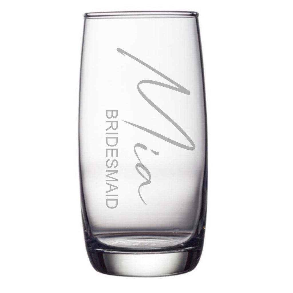 A set of clear engraved hiball glasses displayed on a reflective surface, with one glass engraved with the name 'Olivia'.