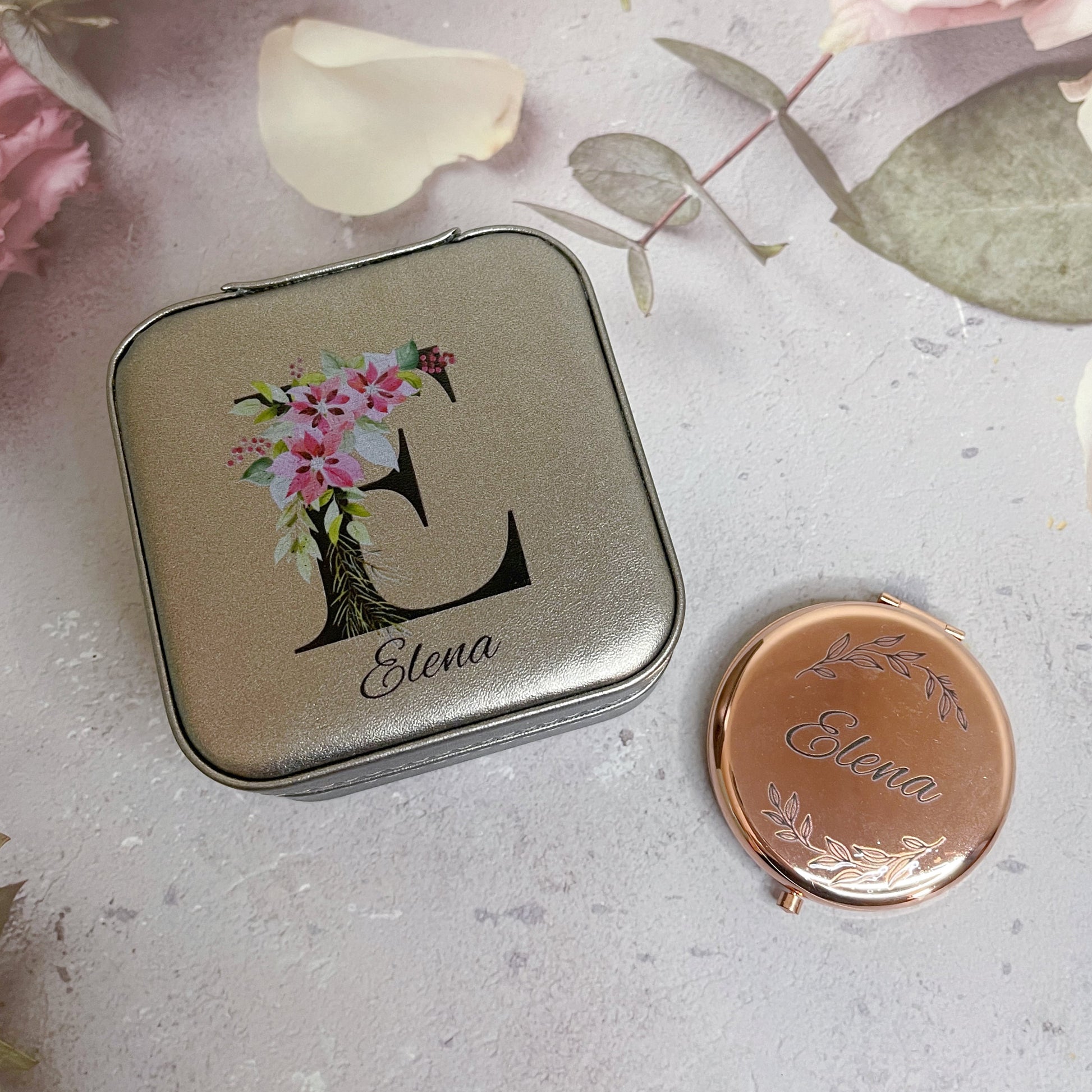 A personalized travel jewellery box and metallic compact mirror bundle with floral patterns and engraved initials.