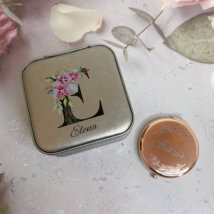 A personalized travel jewellery box and metallic compact mirror bundle with floral patterns and engraved initials.