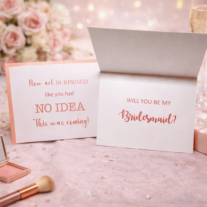 Two cards with 'Will you be my Bridesmaid?' question on a decorative background with flowers and makeup.