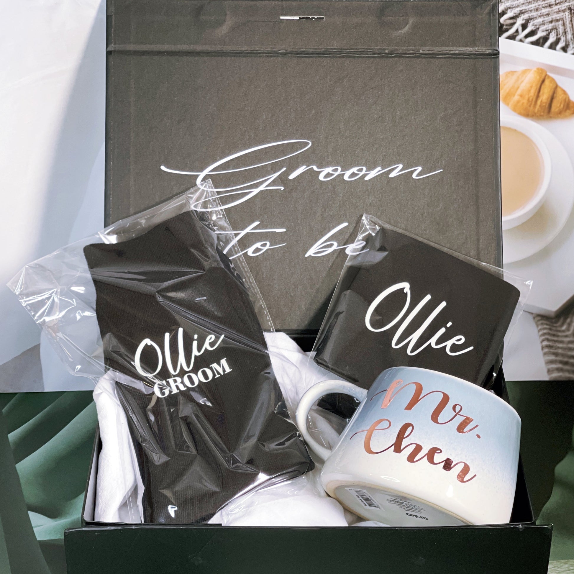 A gift box for the groom, with personalized text on the inside and outside of the box, including a black stubby holder, a pair of personalized socks, and a mug with 'MR. CHEN' written on it.