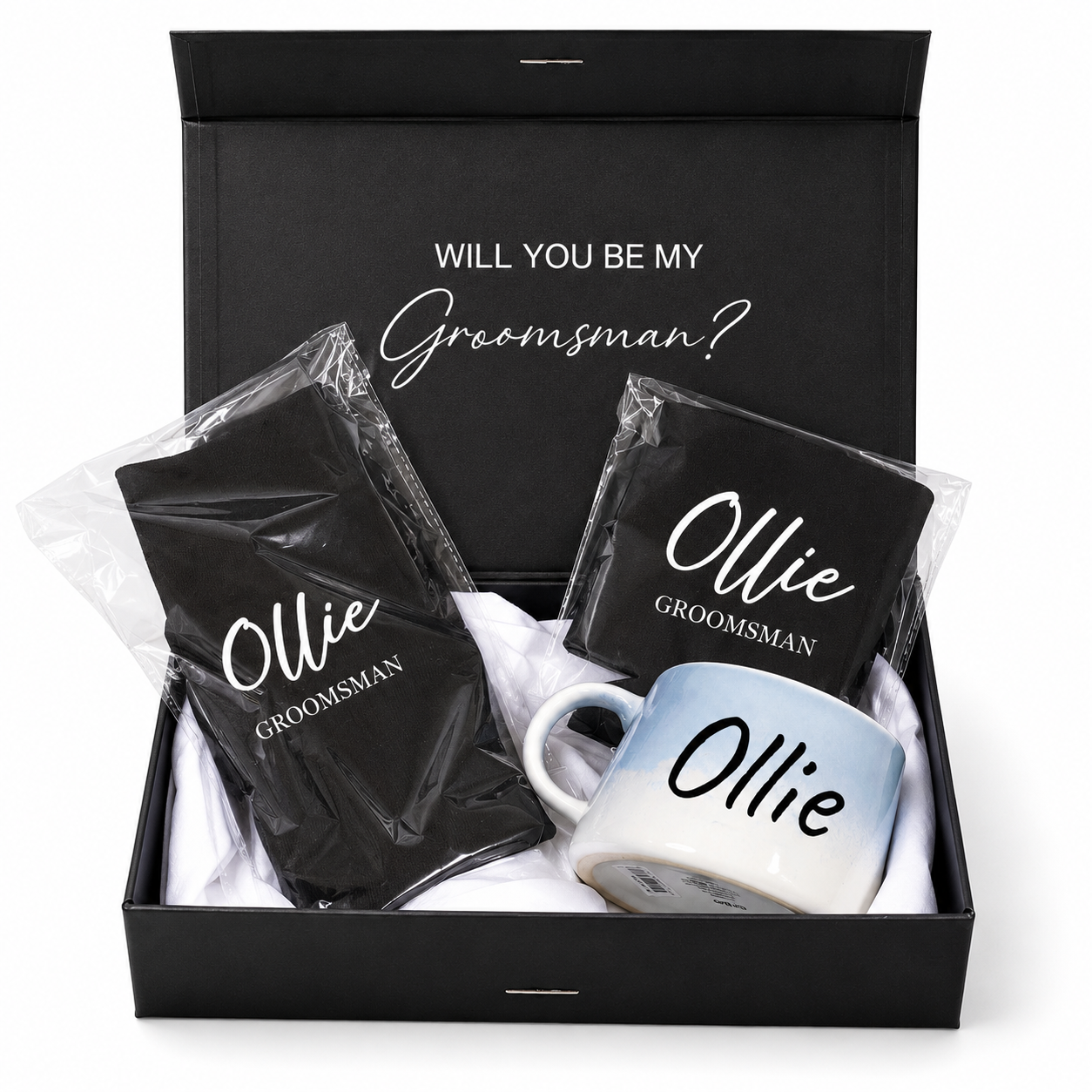 Gift set with 'Will you be my Groomsman?' message, mug, and black napkins in a box.