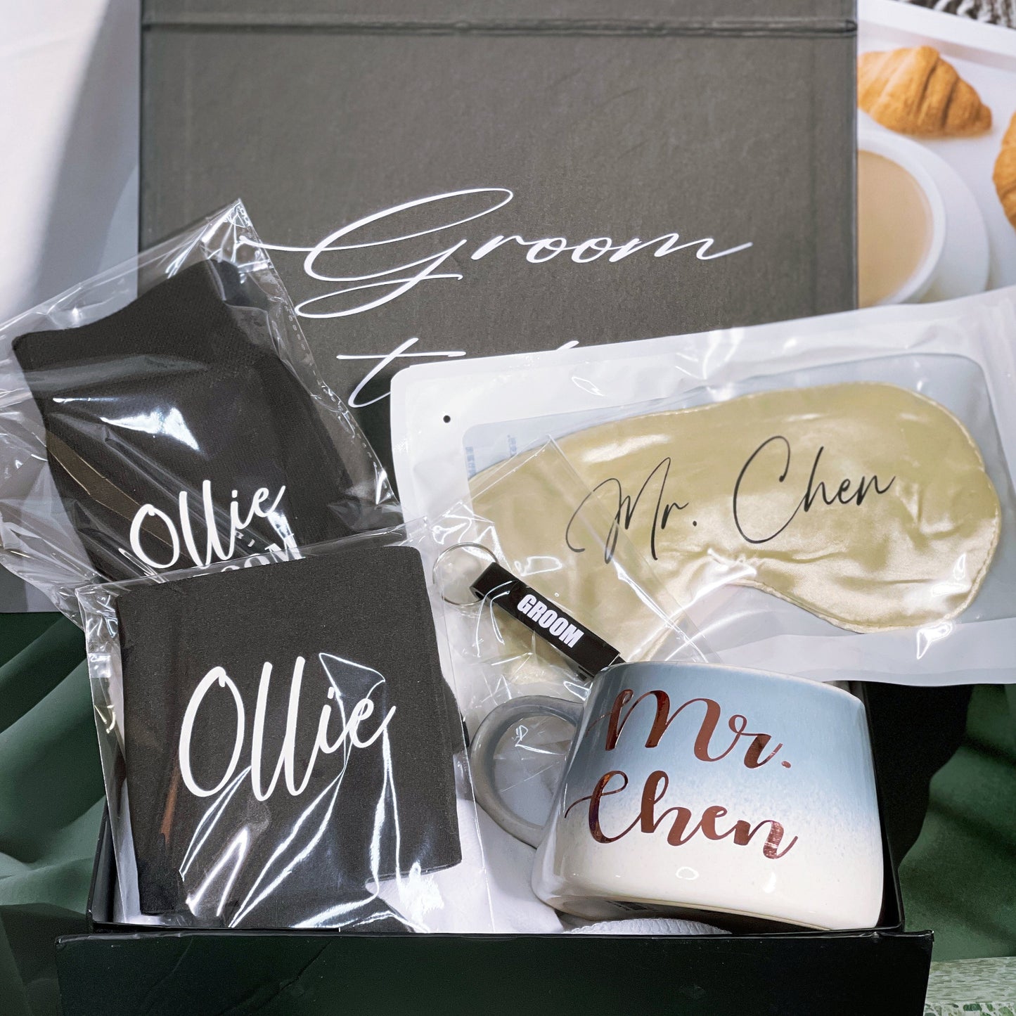 A gift box for the groom containing various personalized items including a black stubby holder, personalized socks, an eye mask, and a bottle opener, all packaged in a box with 'Groom to Mr. Chen' printed on it.