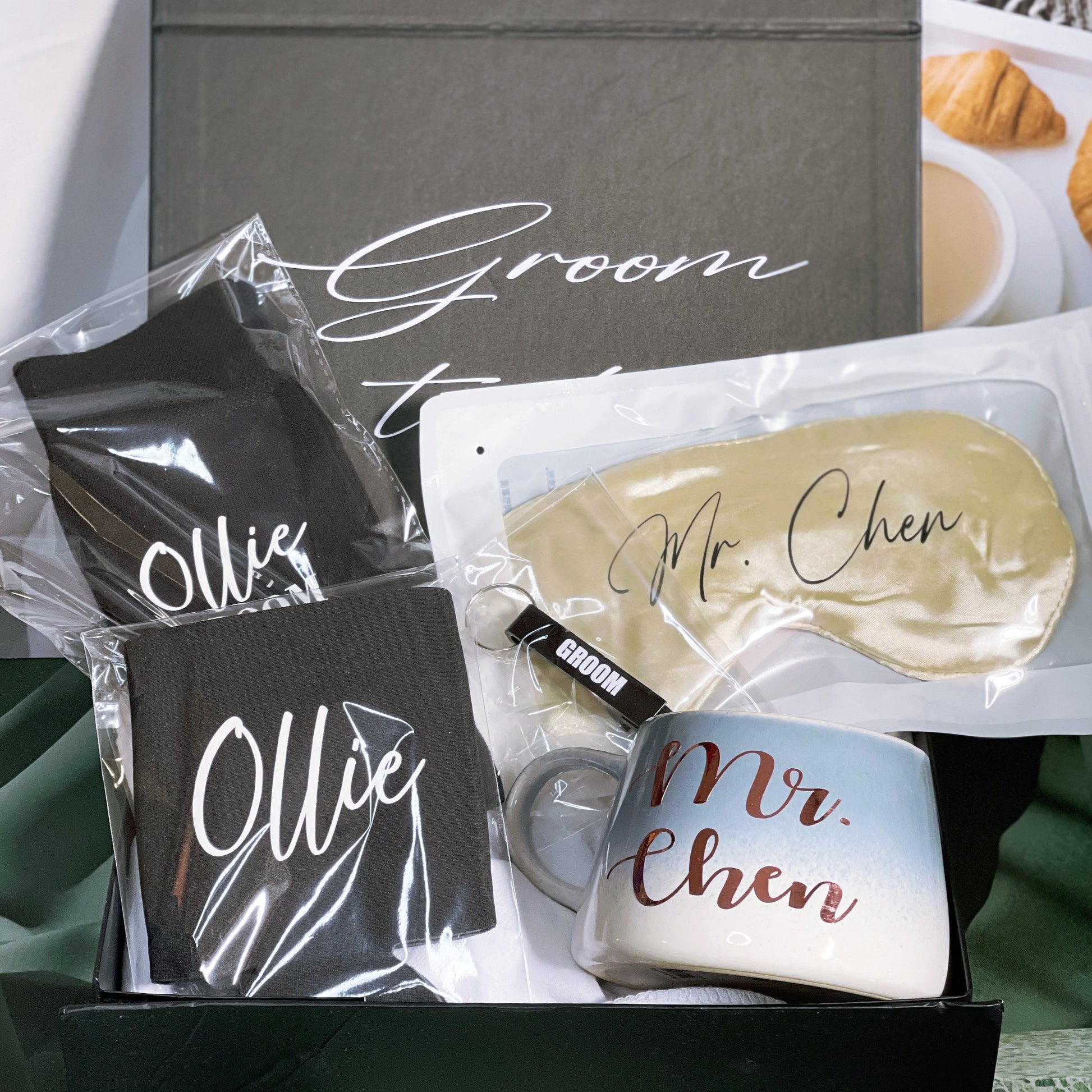 A gift box for the groom containing various personalized items including a black stubby holder, personalized socks, an eye mask, and a bottle opener, all packaged in a box with 'Groom to Mr. Chen' printed on it.