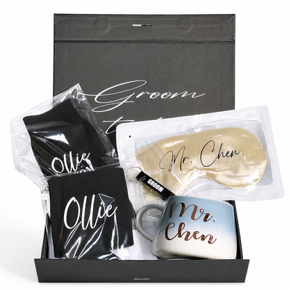 Gift set with mugs, sleep mask, and black pouches labeled 'Ollie' and 'Mr. Chen' in a black box.