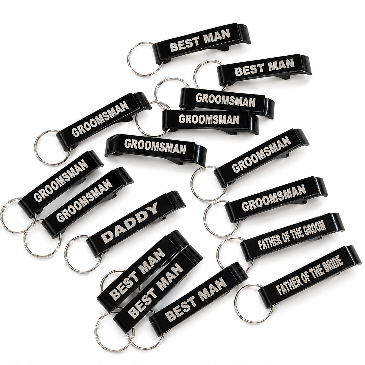 Black keychains with white text for groomsmen on a white background