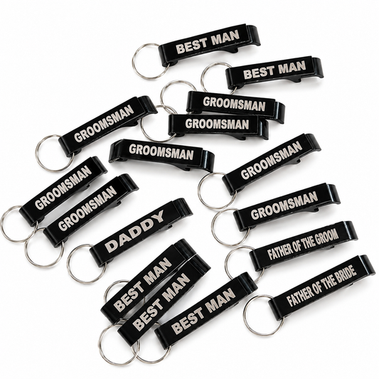 Black keychains with white text for groomsmen on a white background