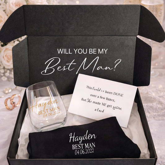 Gift set with 'Will you be my Best Man?' proposal card, glass, and black shirt in a box.