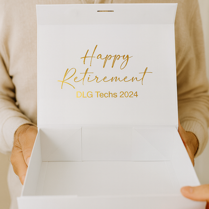 Person holding a white box with 'Happy Retirement OLG Techs 2024' text.