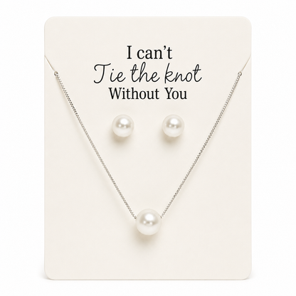 Pearl necklace and earrings set on a card with 'I can't tie the knot without you' text.