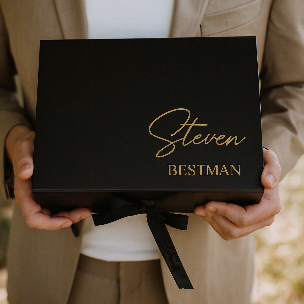 Person holding a black box with 'Steven Bestman' written on it, wearing a beige suit.
