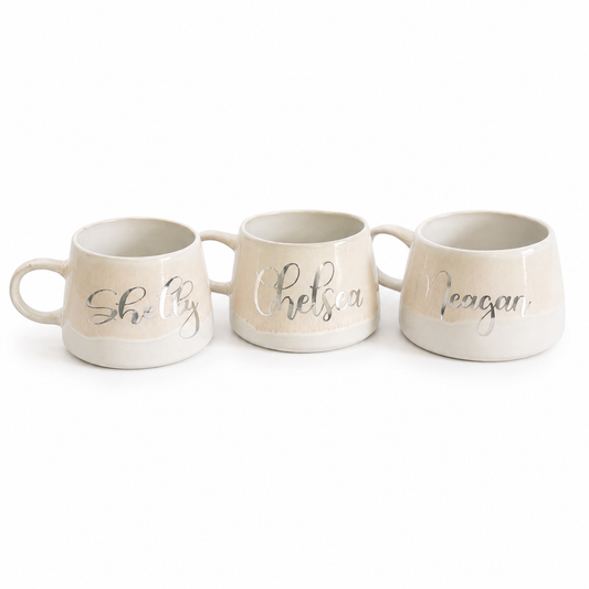 Three ceramic mugs with personalized names on a white background