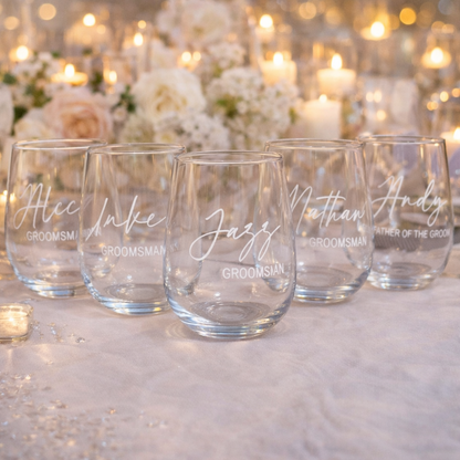 Set of personalized glass tumblers with names on a decorative background