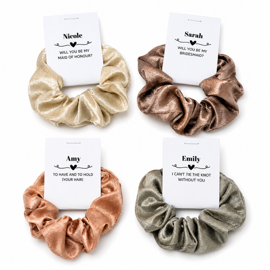 Four metallic scrunchies with personalized cards on a white background