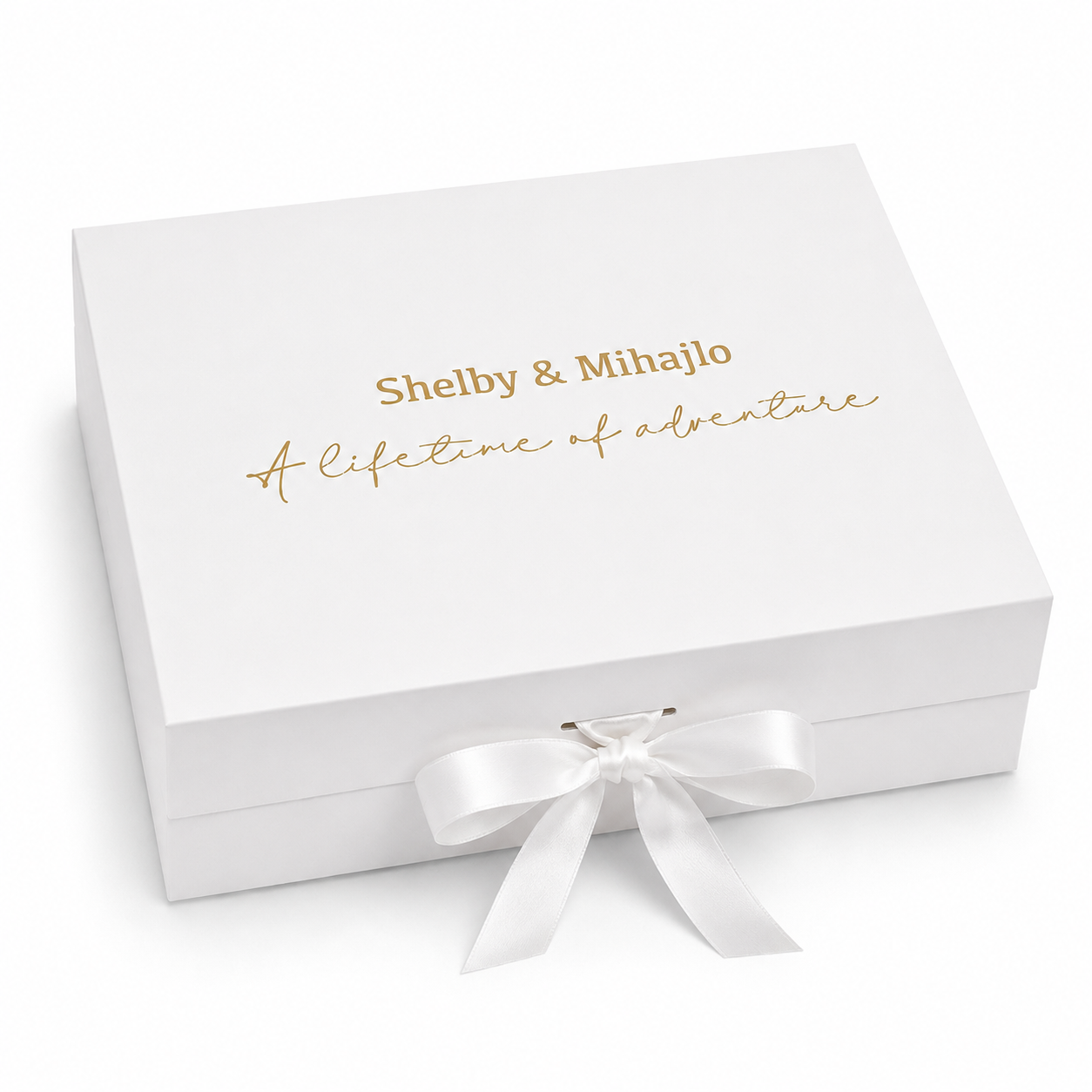 White gift box with gold text and a white ribbon on a white background