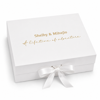 White gift box with gold text and a white ribbon on a white background