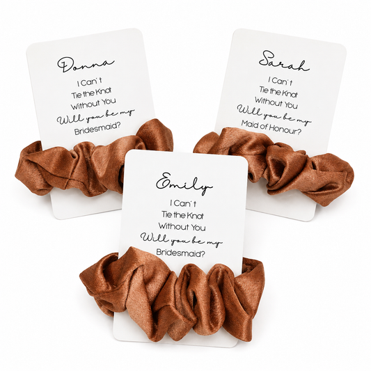 Three brown scrunchies on cards with personalized requests for bridesmaids on a white background