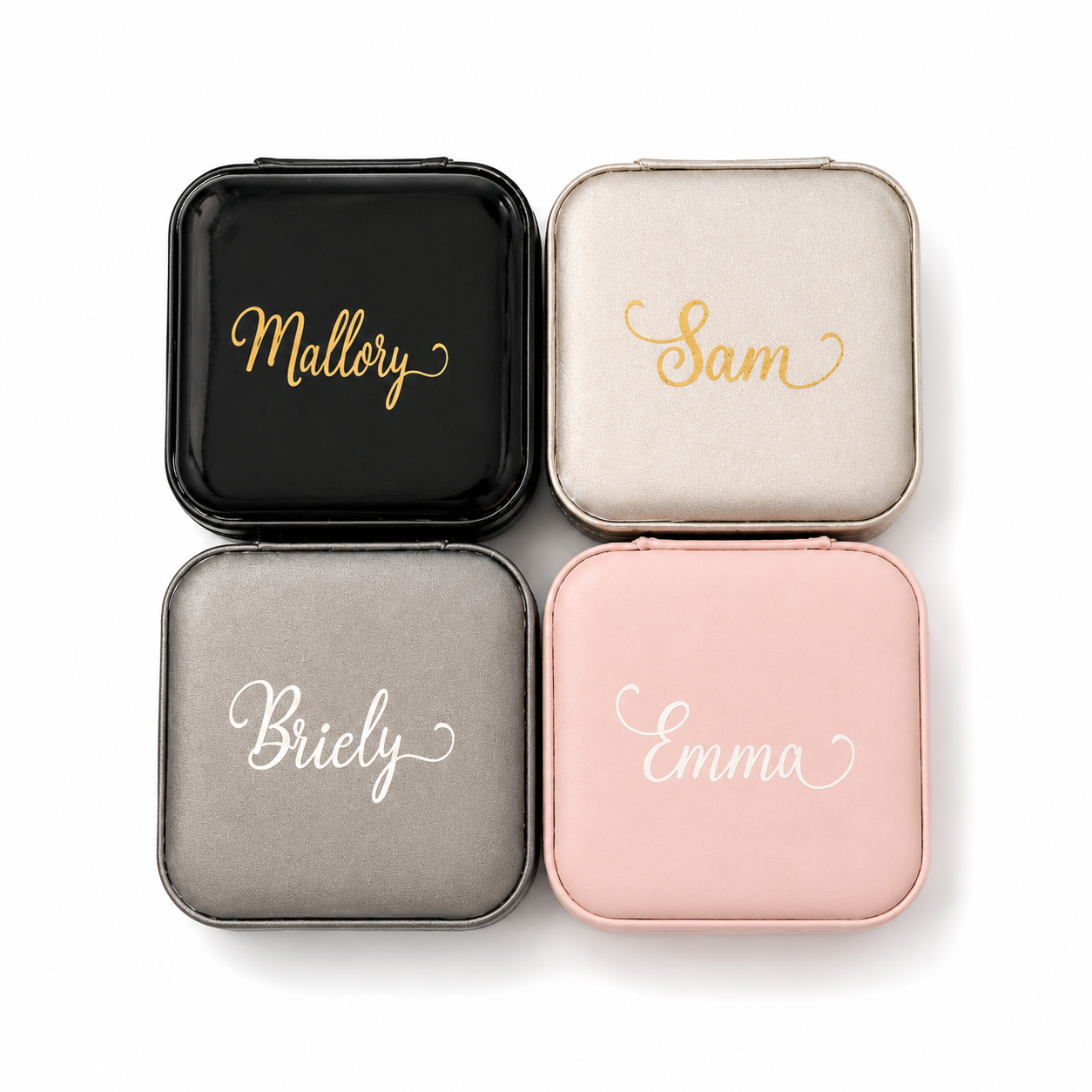 Four square jewelry cases with names 'Mallory', 'Sam', 'Briely', and 'Emma' engraved on them.