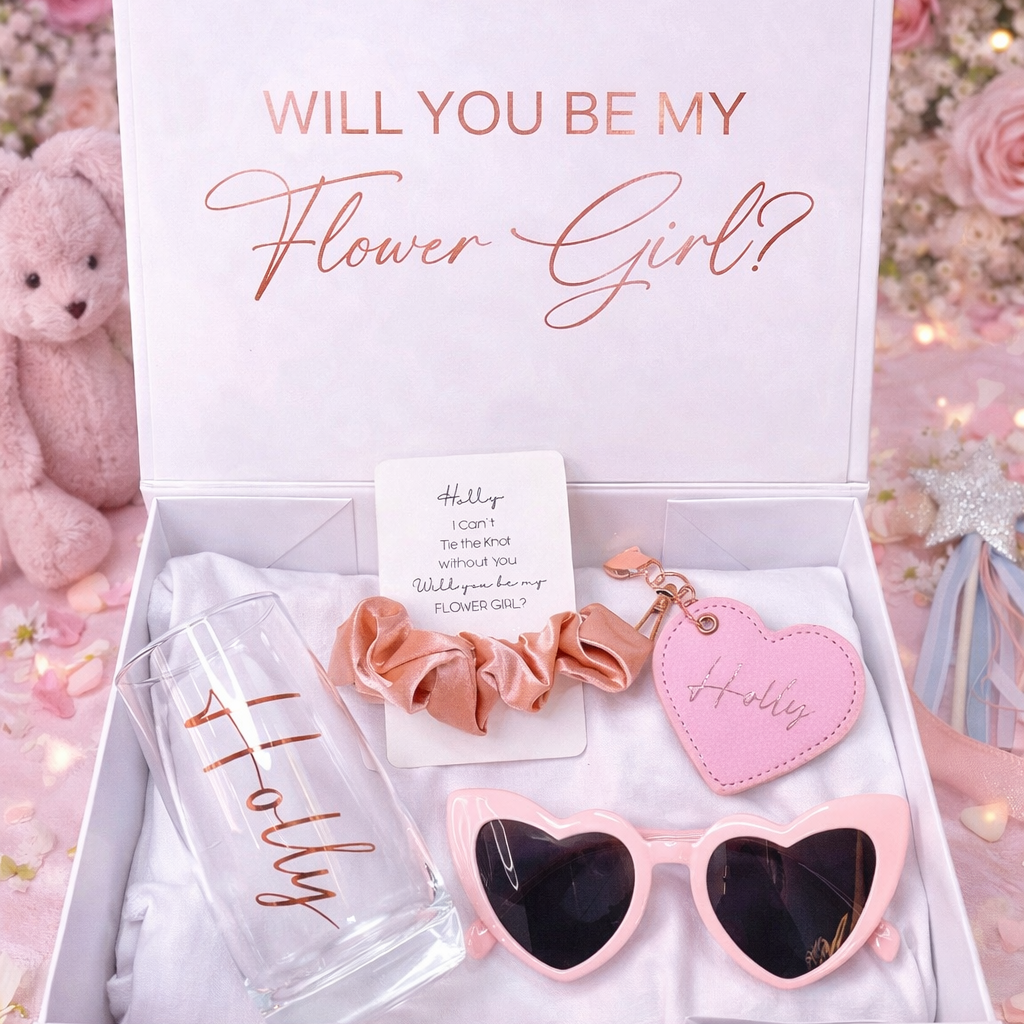 Gift set with 'Will You Be My Flower Girl?' message, sunglasses, scrunchie, and heart-shaped keychain in a box.