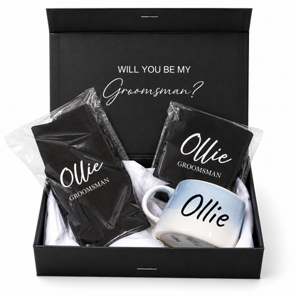 Gift set with 'Will you be my Groomsman?' message, mug, and black napkins in a box.