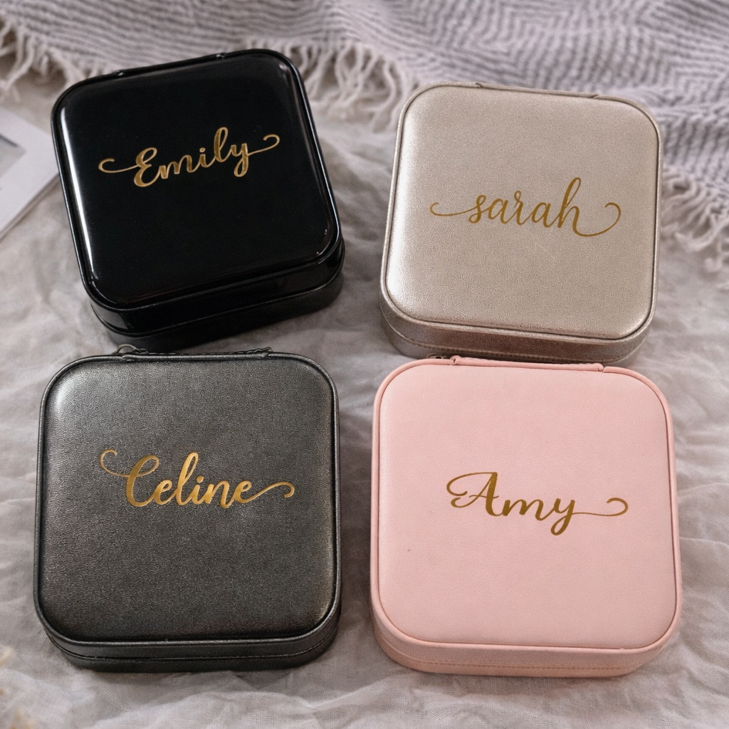 Four jewelry cases with names 'Emily', 'Sarah', 'Celine', and 'Amy' on a textured surface.